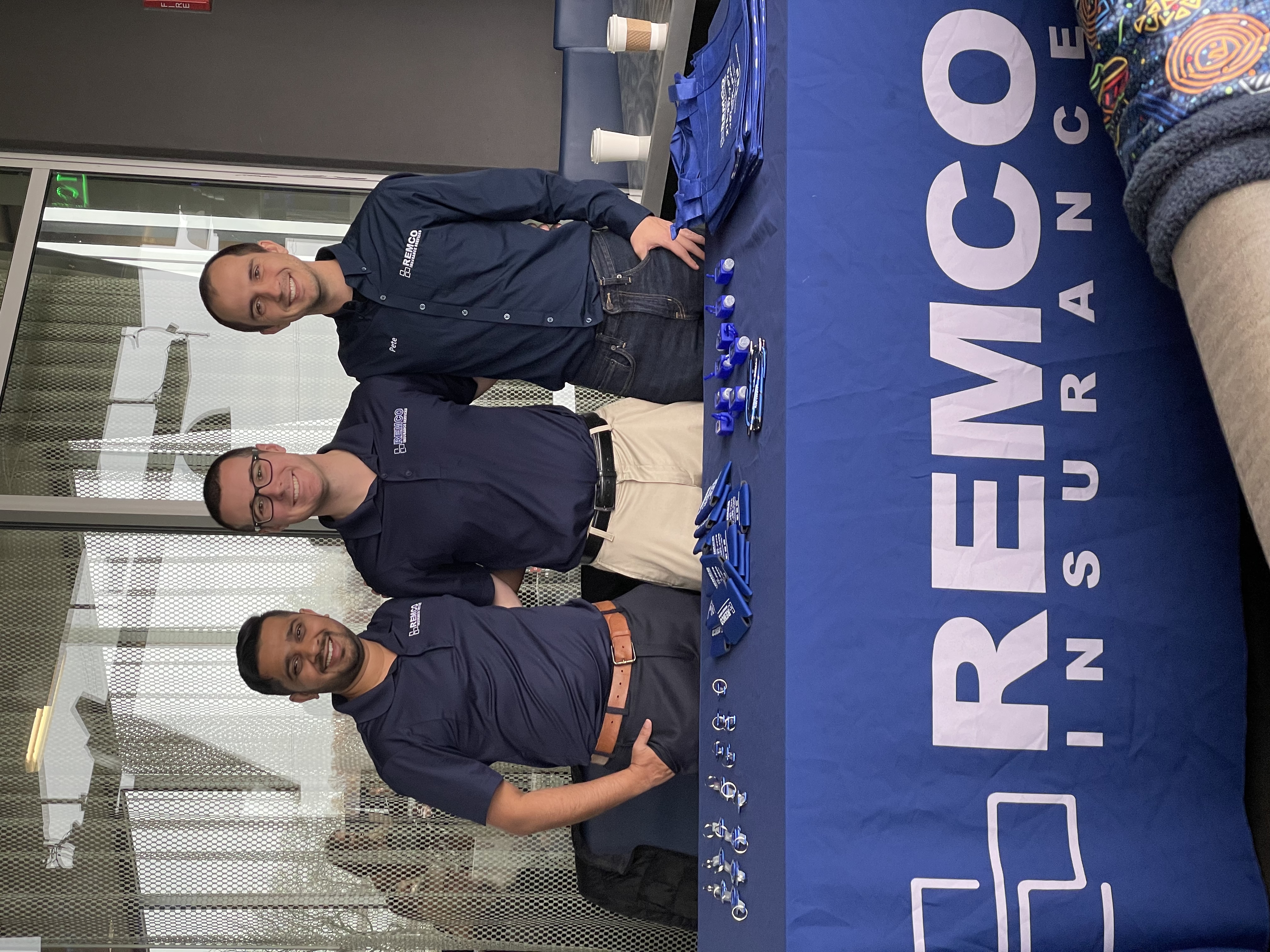 Remco agents at a community event promotional table